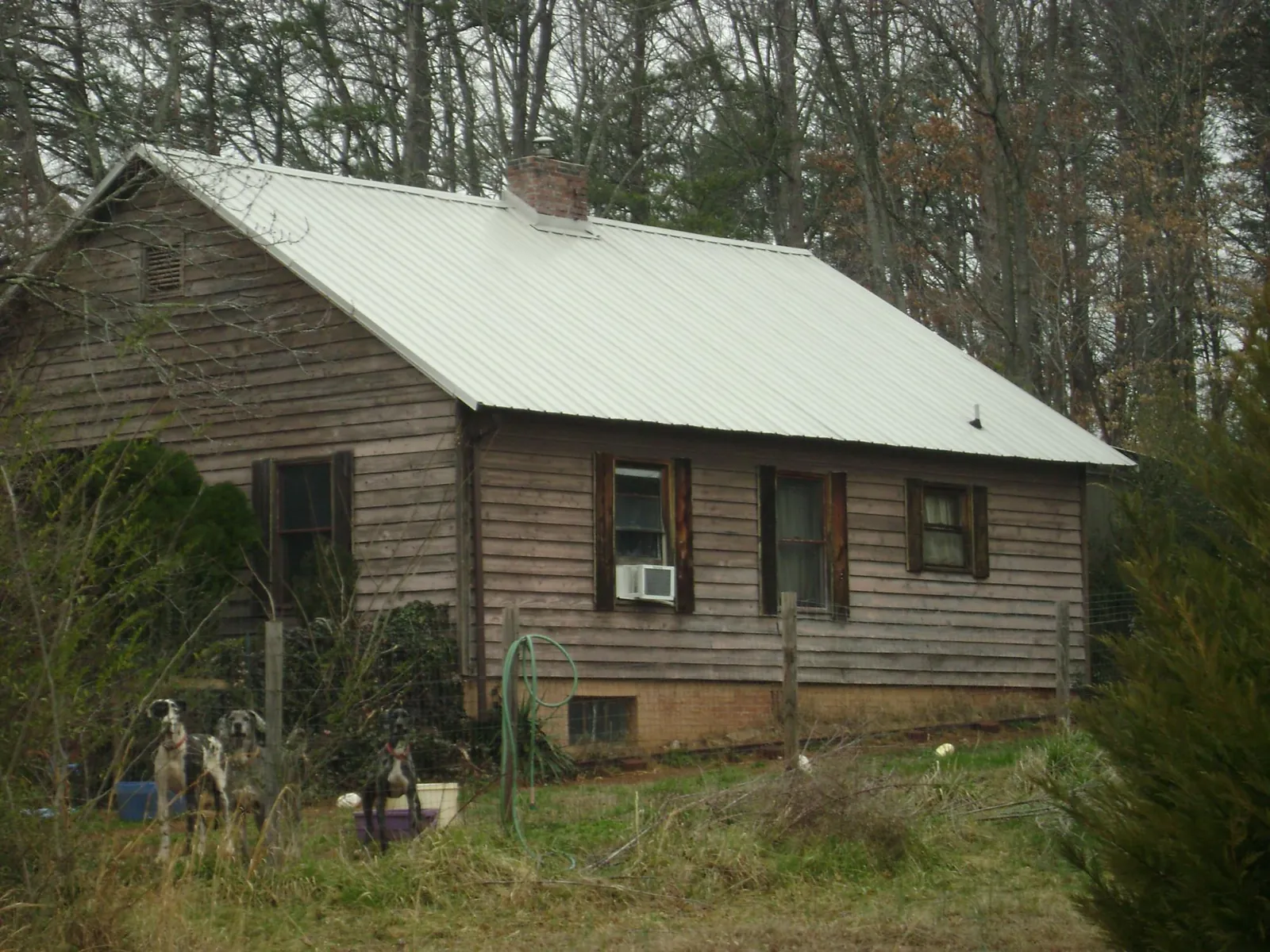 White metal roof on an old wood sided farmhouse, from a Metal Roof Installation job in Paradise